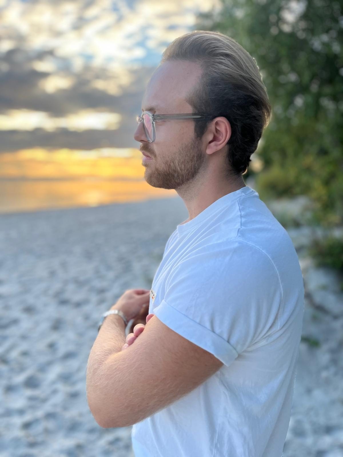 Standing on a beach at sunset, looking out over the water